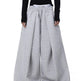 Person wearing gray wide-leg pants with a black top on a white background