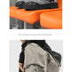 A pair of black and gray polka-dot lace-up boots shown in two views: one on an orange bench against a gray wall, and another worn with gray cargo pants against a light gray studio background.