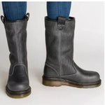 A pair of dark gray leather mid-calf boots with pull tabs and contrast stitching, shown on a person wearing blue jeans against a plain light background.