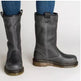A pair of dark gray leather mid-calf boots with pull tabs and contrast stitching, shown on a person wearing blue jeans against a plain light background.