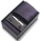 Purple patterned tie set with tie clip and pocket square in a black box on a white background