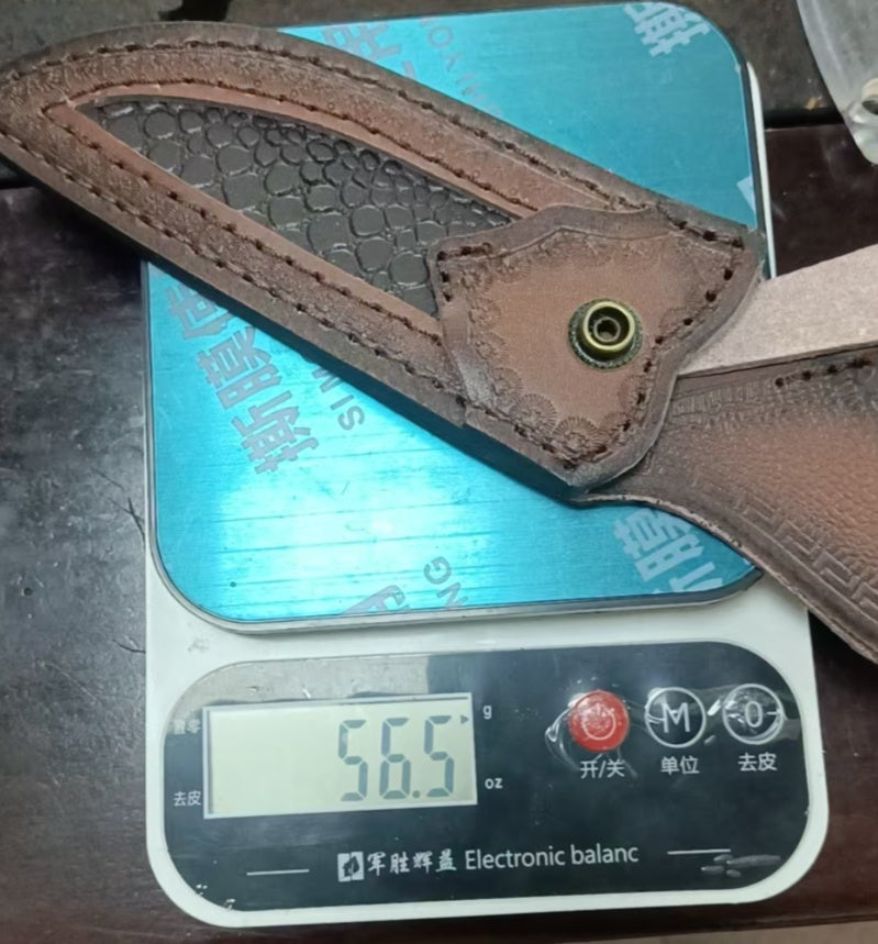 Brown leather belt with a metal buckle on a digital scale displaying weight.