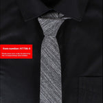 Gray tie on a black shirt with a red item number label.