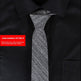 Gray tie on a black shirt with a red item number label.