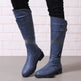 Blue knee-high boots on a light background