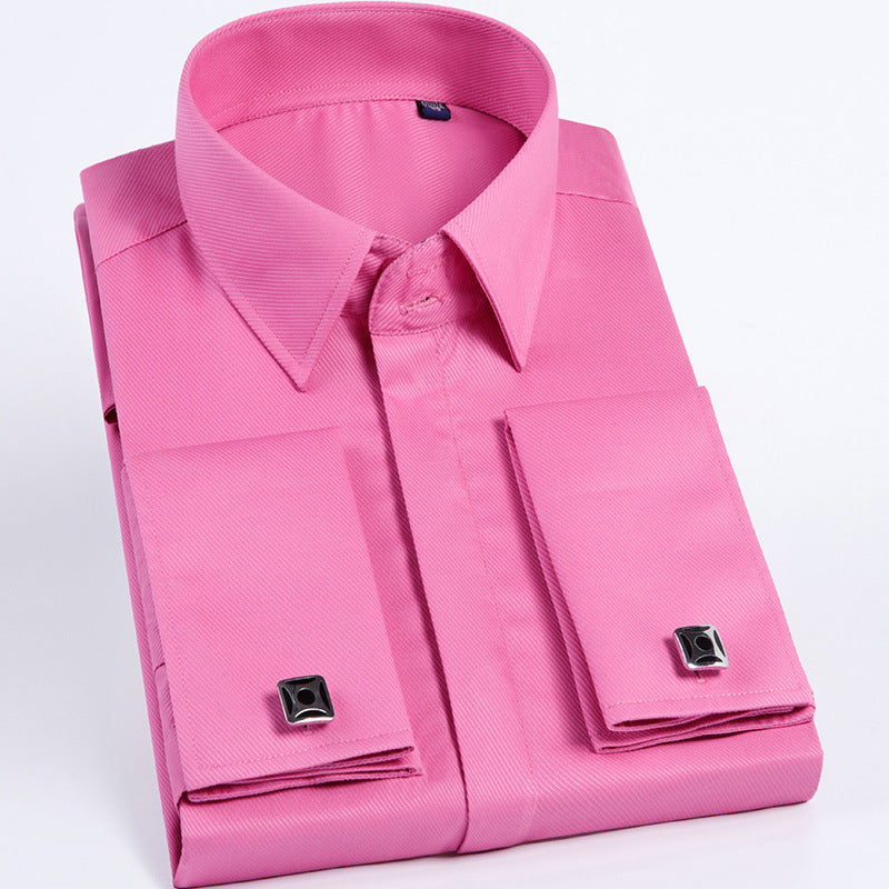 Folded pink dress shirt with cufflinks on a light gray background
