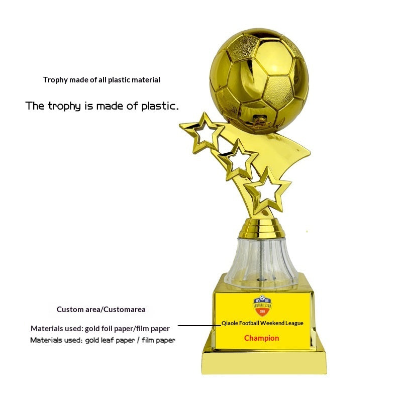 A gold plastic soccer trophy with a soccer ball on top, three star cutouts, a clear glass cone, and a gold base featuring a printed 'Champion' plaque with a football league logo. Text annotations describe the product and materials on a white background.