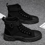 Black high-top boots on a textured gray surface