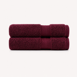 Two folded bath towels in a deep burgundy color, stacked vertically on a clean, light off-white background. Pure Cotton Bath Towel Set – Burgundy & Turquoise (74x33cm to 170x95cm)
