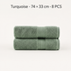 Two folded turquoise towels stacked on a light gray background, with text at the top reading 'Turquoise • 74 × 33 cm • 8 PCS'.